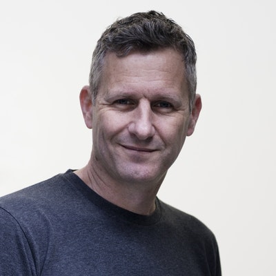 portrait photo of Adam Hills
